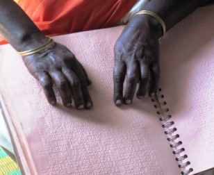 hands reading braille
