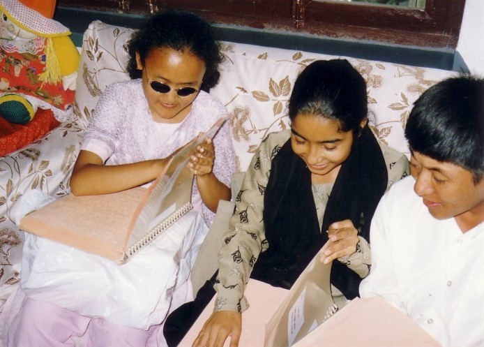Visually impaired people reading Nepali braille Bible