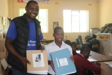 Distributing braille Scriptures to school children.