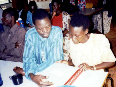 A man and a woman looking at a braille volume
