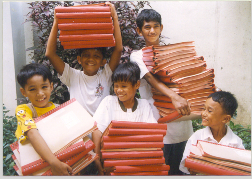 Boys carrying one braille Bible