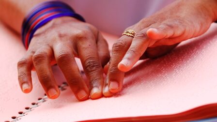 Fingers reading braille