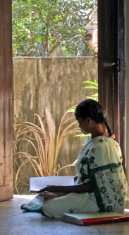 Lady reading braille in doorway